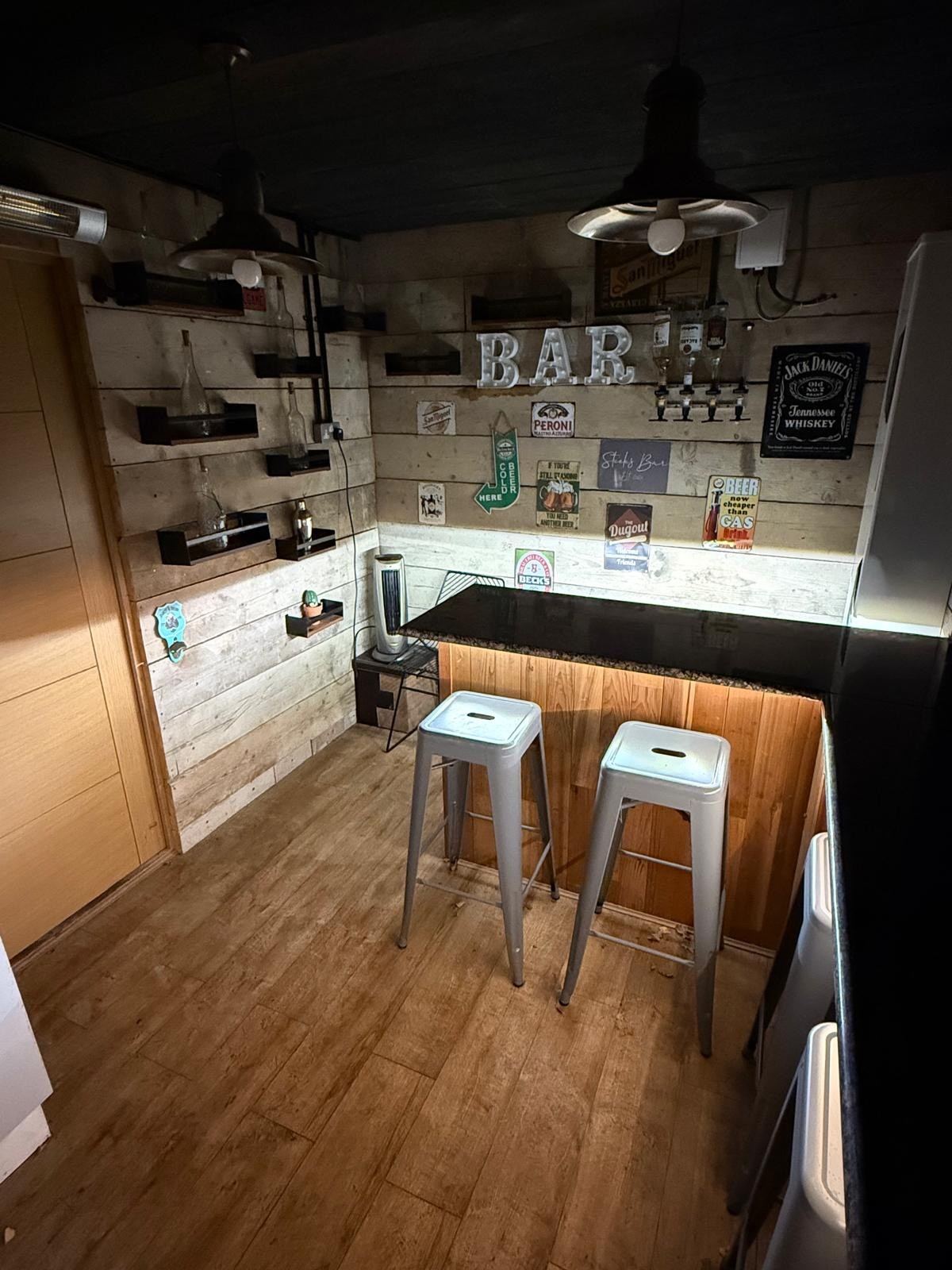 Inside the garden bar, with stools and a serving counter